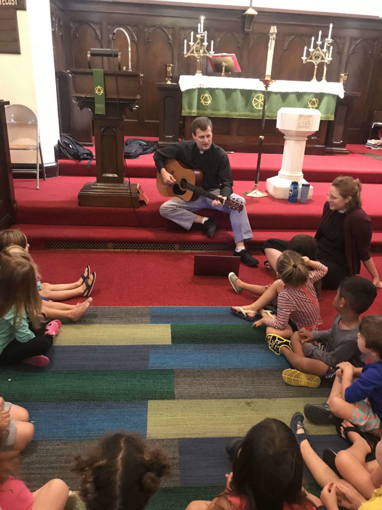 Kids in chapel singing together.